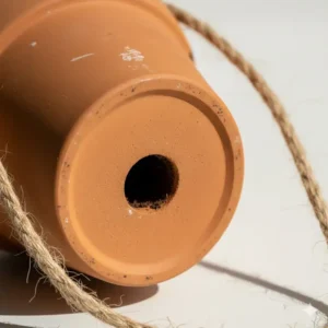 Bottom view of a 4 inch hanging planter highlighting the drainage hole essential for indoor plant health.