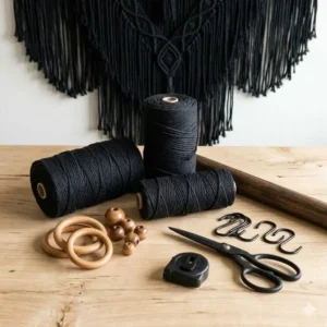 DIY craft supplies featuring spools of 4mm black macrame cord and wooden rings for fiber art projects.