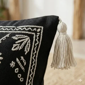 Illustration 4: Detailed illustration of the handmade tassels and fringe on a black boho pillow.