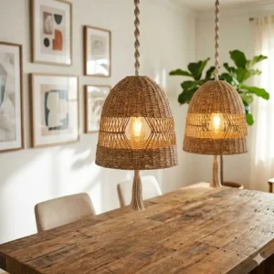 Two tiered bohemian pendant light units centered over a reclaimed wood dining table.