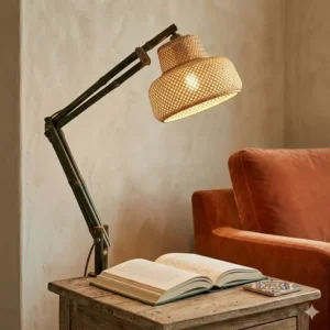 An arched bamboo floor lamp illuminating a reading nook with soft boho lighting.