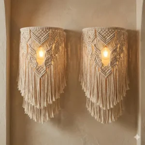 A pair of macramé fringe wall sconces creating ambient boho lighting on a textured wall.